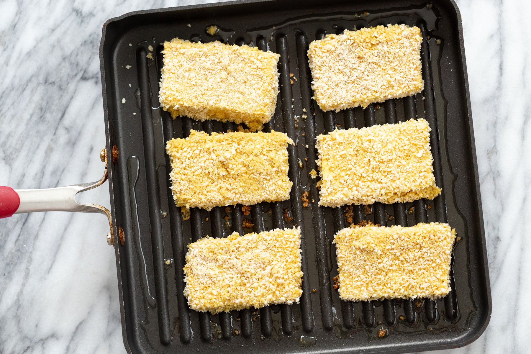 katsu curry breaded tofu slices being fried in a pan