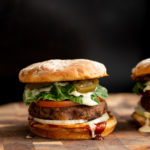 side view of a vegan black bean quinoa burger topped with vegan ranch and jalapenos
