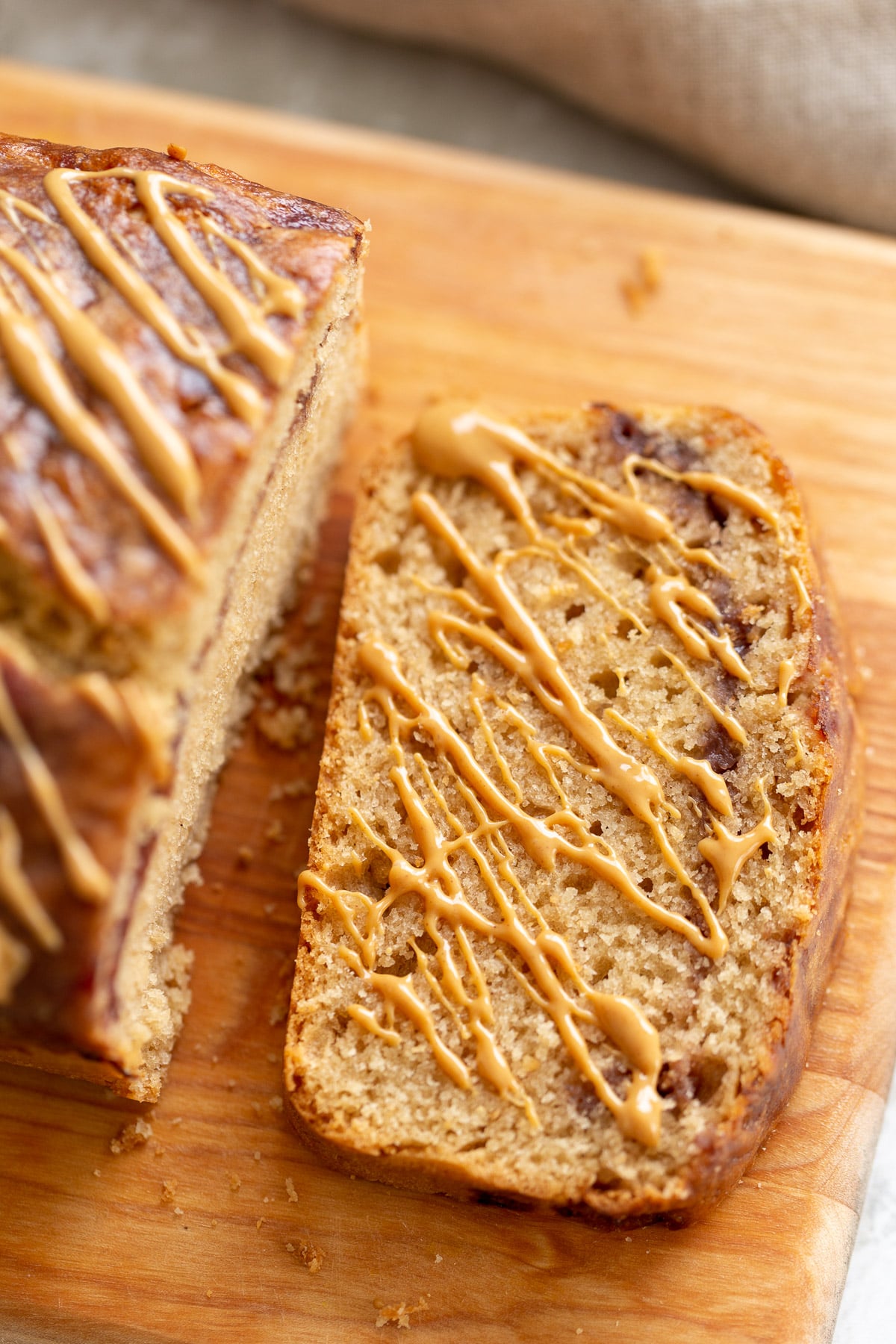 peanut butter and jelly cake a slice of vegan peanut butter and jelly loaf cake drizzled with peanut butter