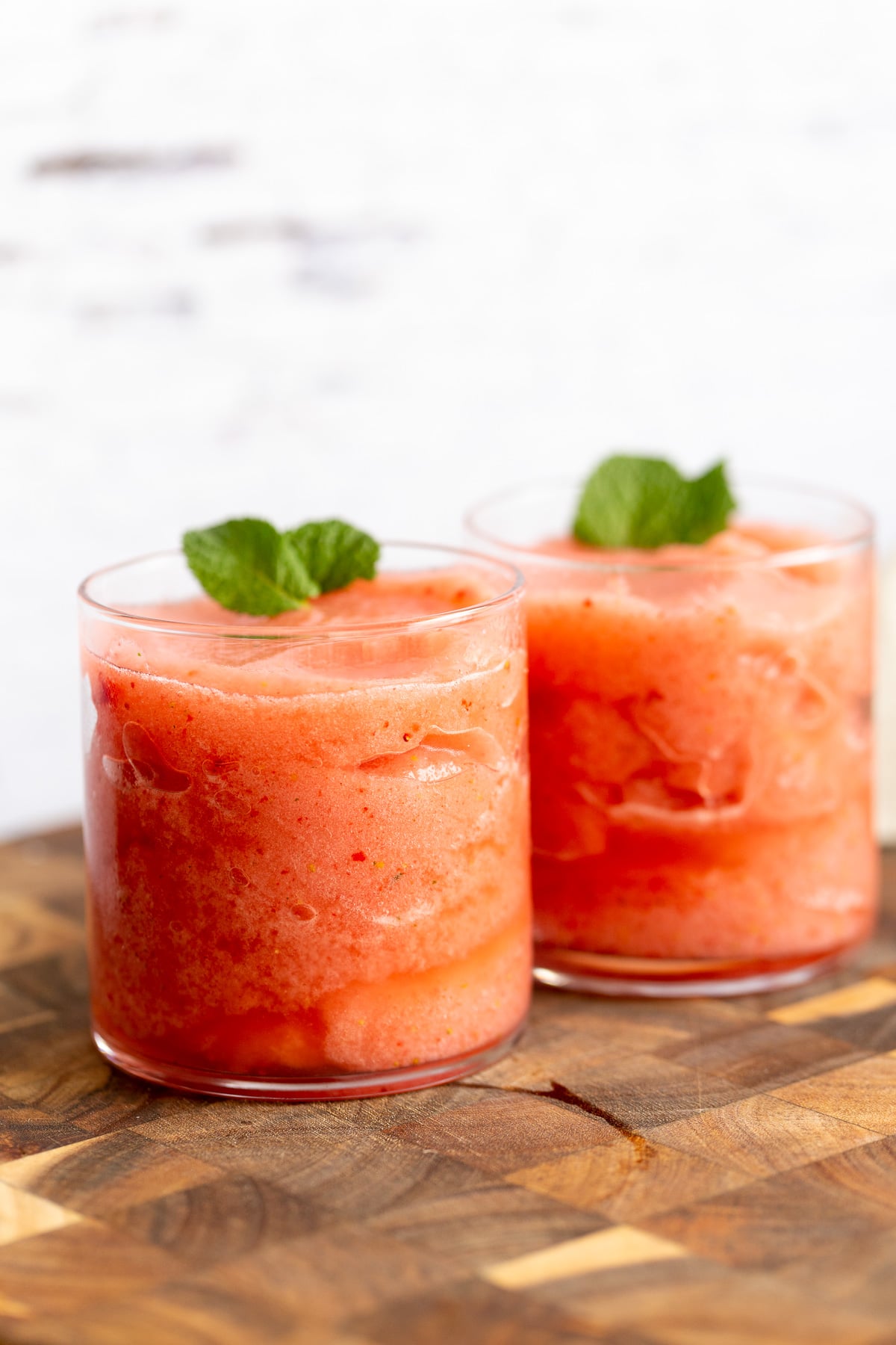 lemonade slushies two glasses with homemade vegan strawberry lemonade slushies