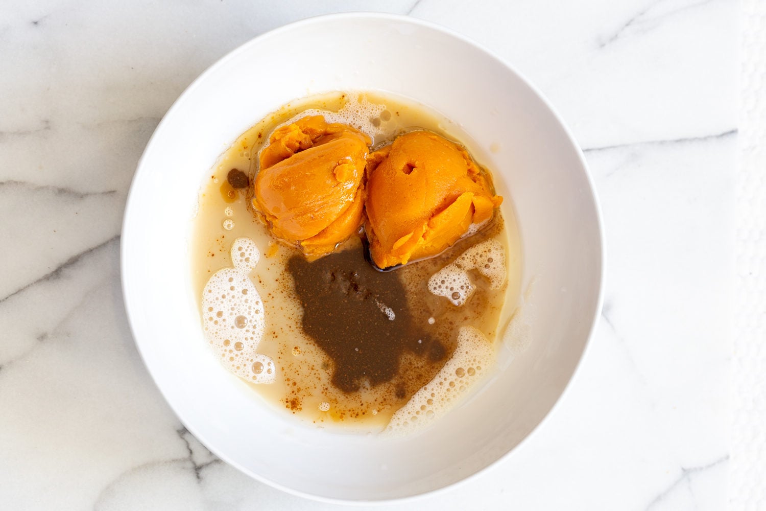 vegan carrot bread wet ingredients for vegan pumpkin bread in a white bowl