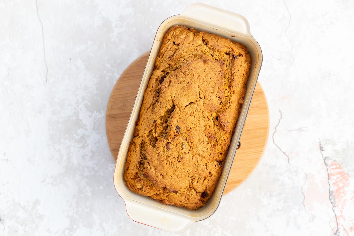 vegan carrot bread a freshly baked loaf of vegan pumpkin carrot bread cooling on a chopping board
