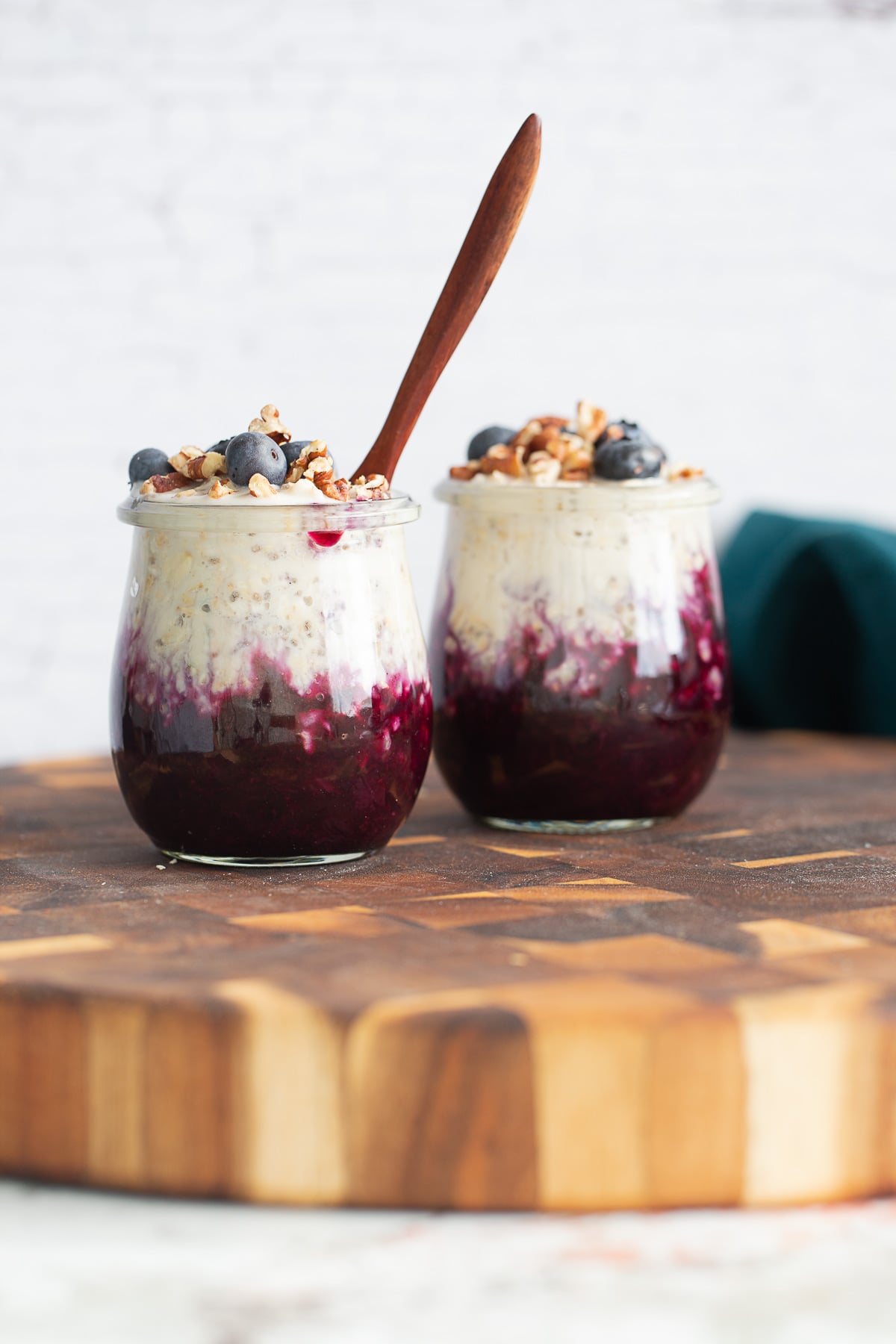blueberry muffin overnight oats topped with blueberries and chopped pecans