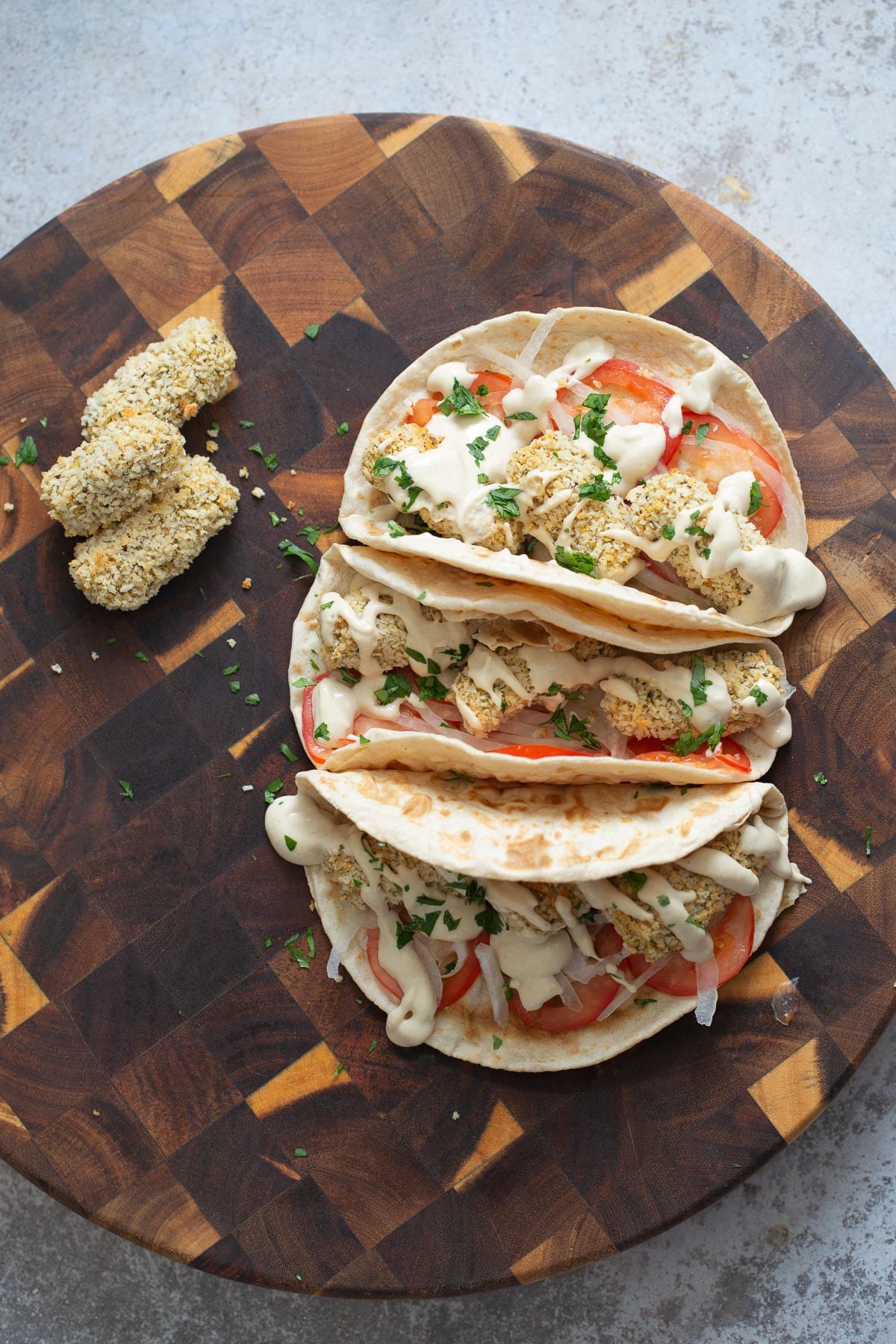 vegan croquettes three wraps filled with vegan chickpea quinoa croquettes on a chopping board
