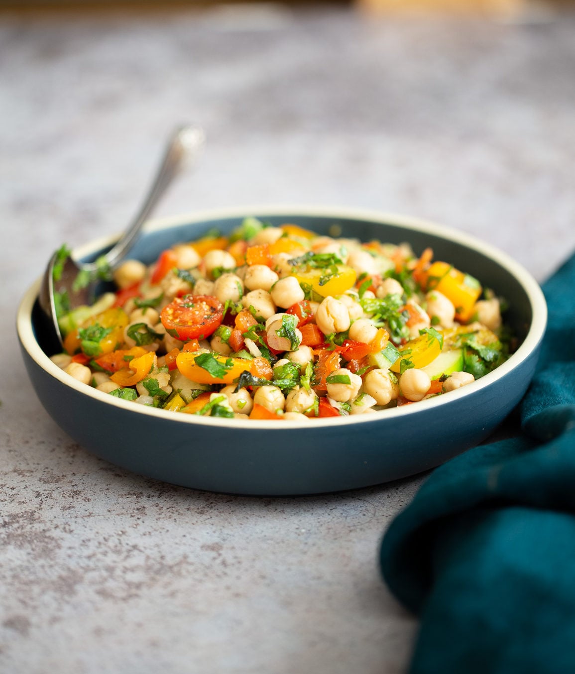 Mediterranean Chickpea Salad side view of a dish of Mediterranean vegan chickpea salad with lemon garlic dressing