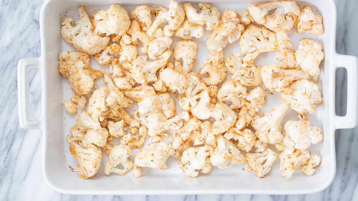 cauliflower salad cauliflower florets sprinkled with bbq spices ready for roasting