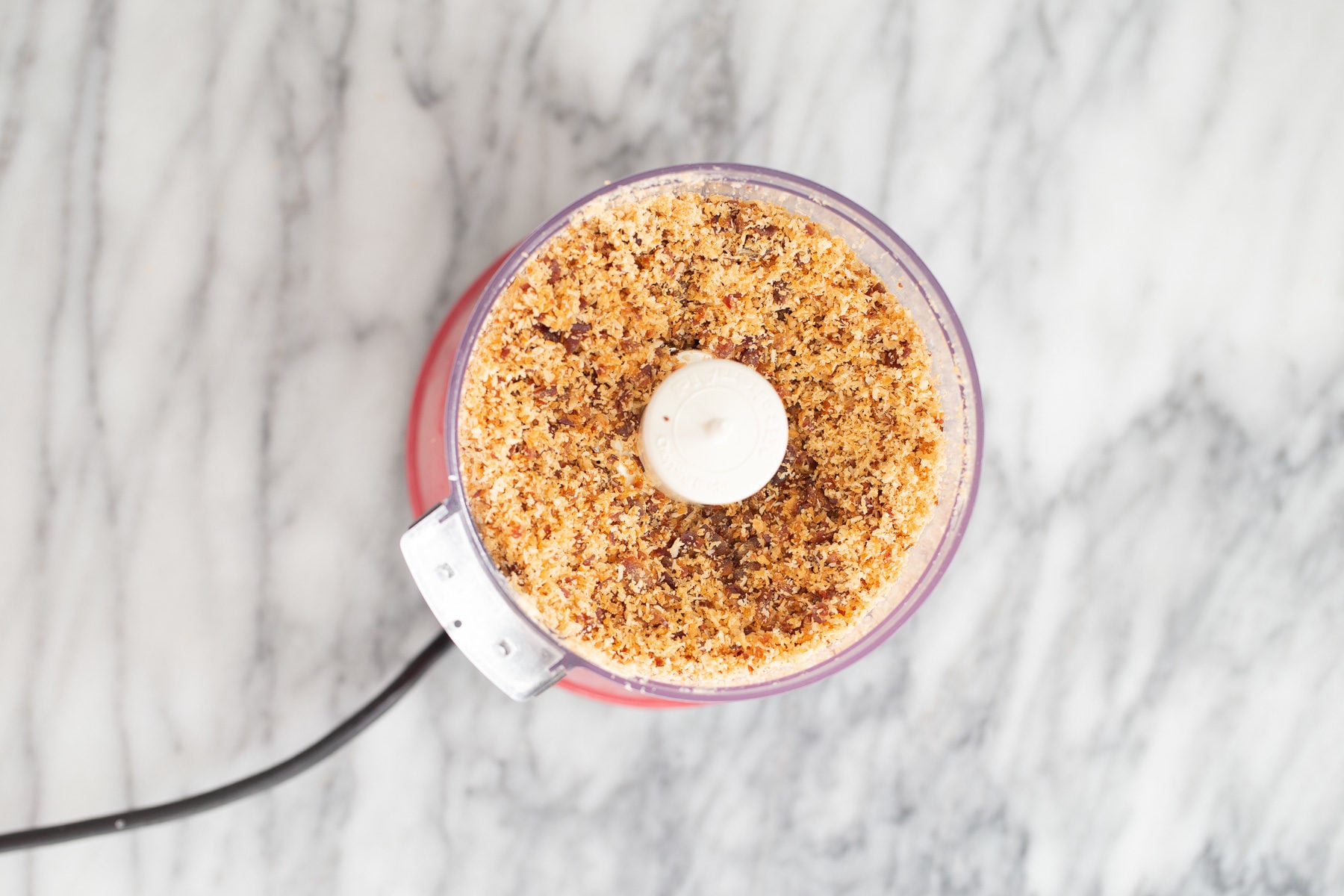 vegan date bars shredded coconut being blended with dates