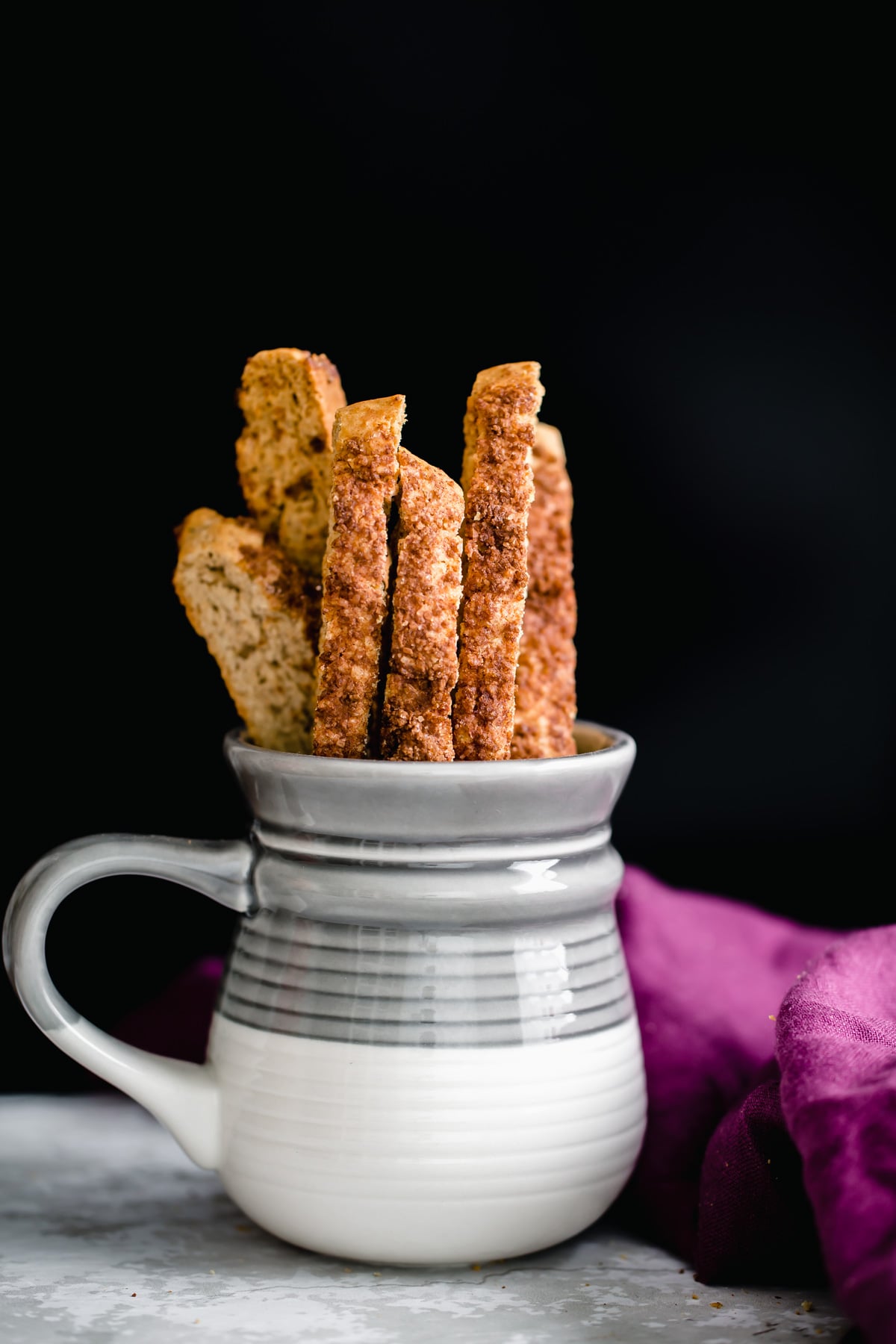 vegan biscotti a coffee mug with vegan cinnamon sugar biscotti