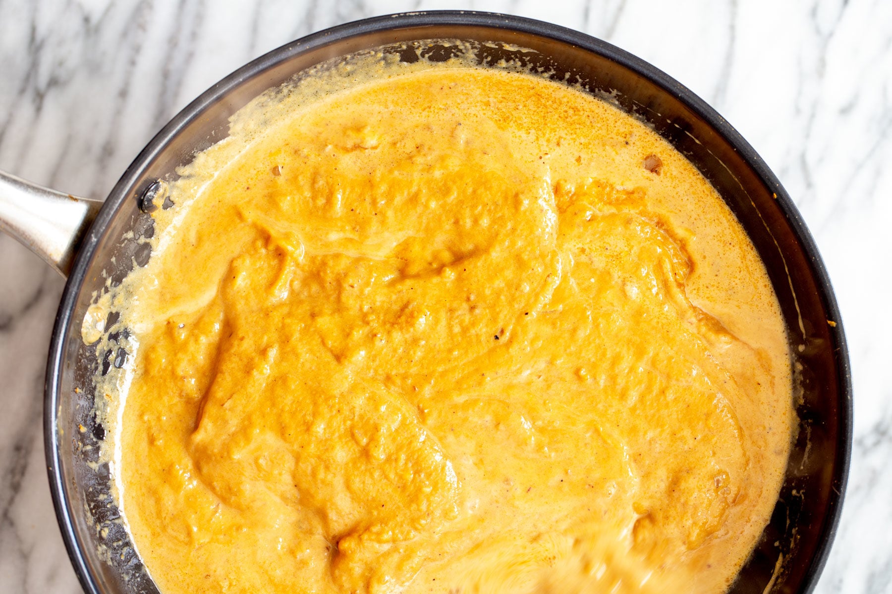 pumpkin curry overhead shot of a skillet with simmering pumpkin curry