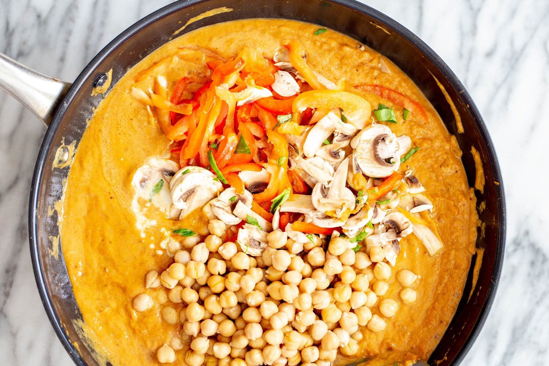 pumpkin curry veggies being added to pumpkin curry base