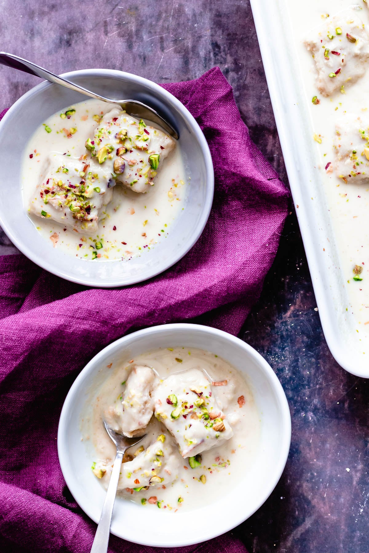 rasmalai cake overhead shot of two servings of vegan rasmalai cake