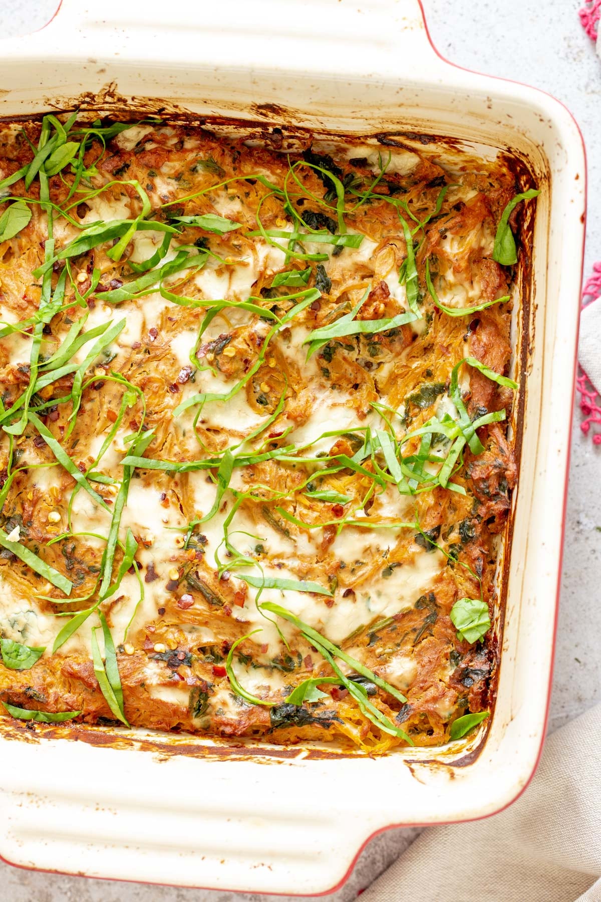vegan Italian Sun-dried tomato Spaghetti Squash Pasta Bake in a white casserole dish 