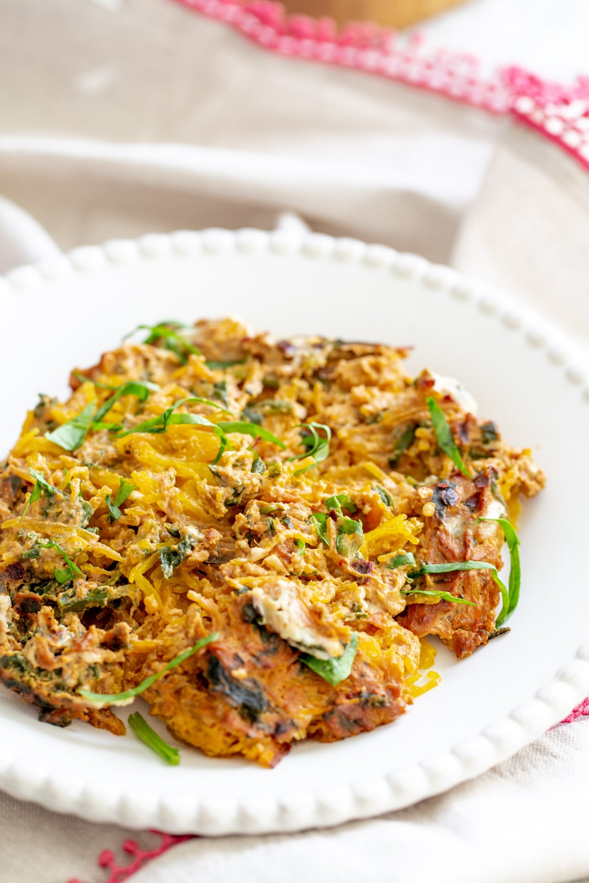 side view of a plate with vegan spaghetti squash bake with creamy tomato sauce