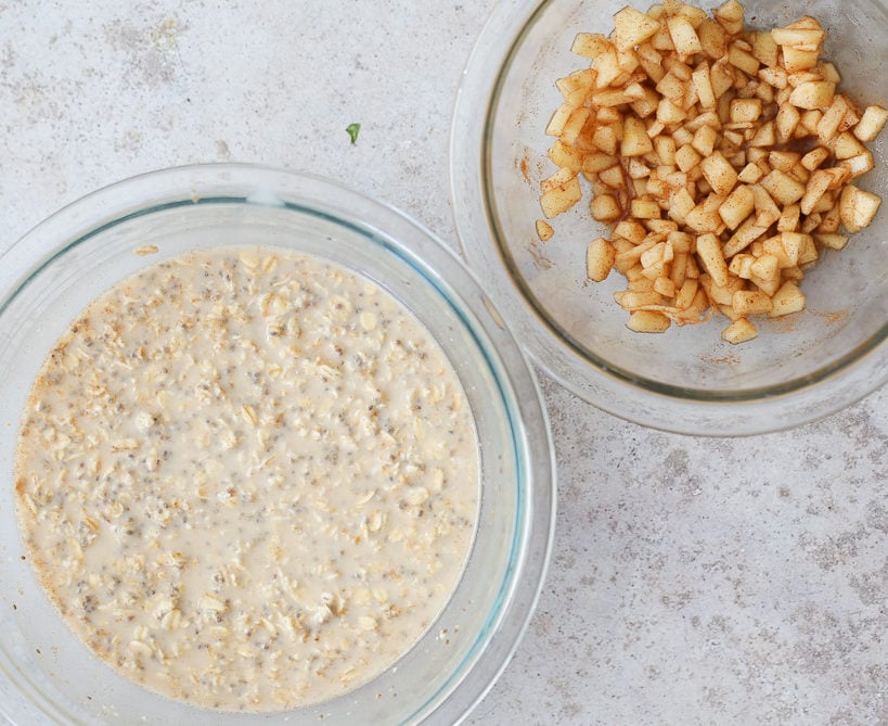 apple pie overnight oats a bowl with overnight oats with chia seeds next to a bowl with apple mixture