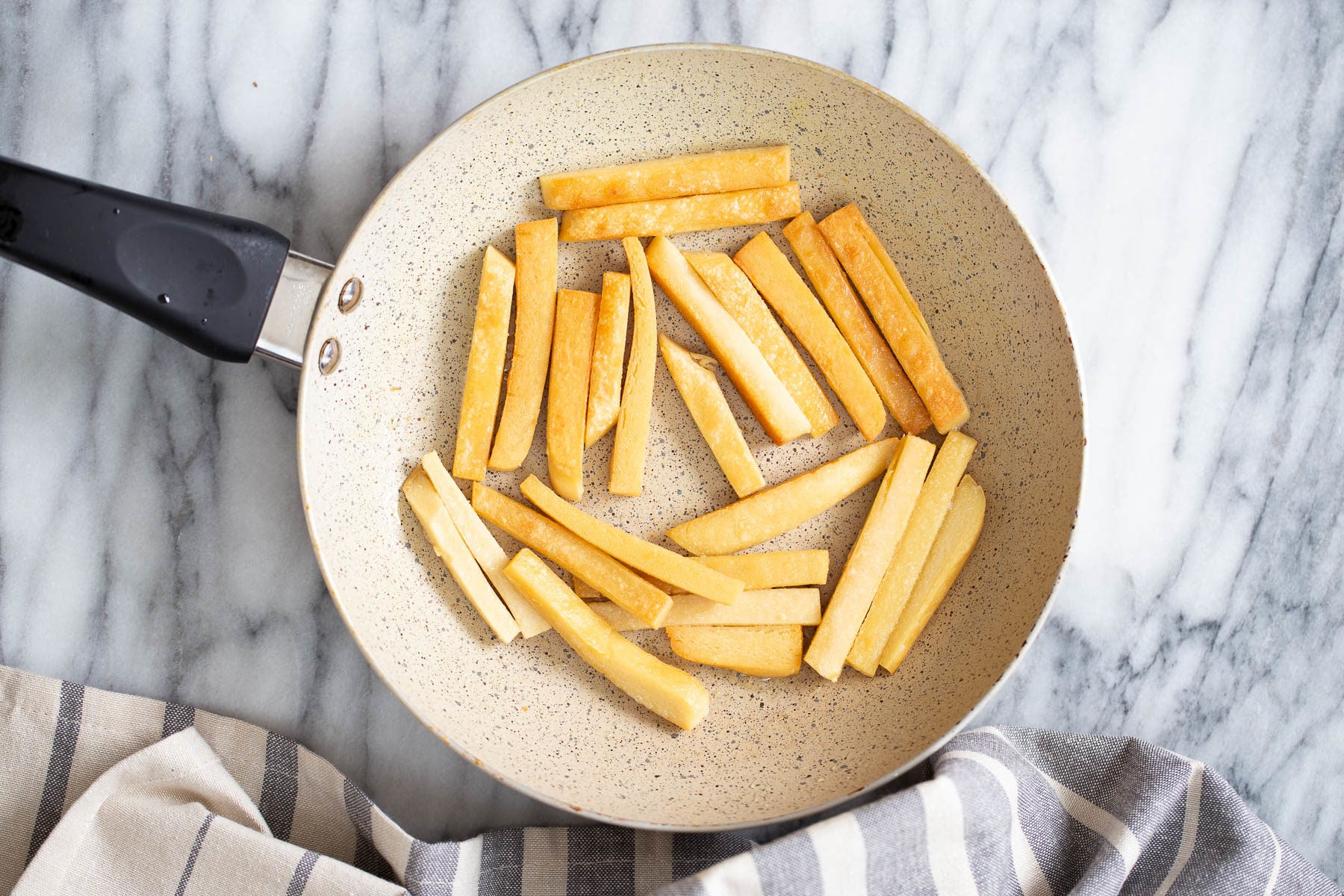 chickpea fries chickpea flour fries being pan-fried in a skillet