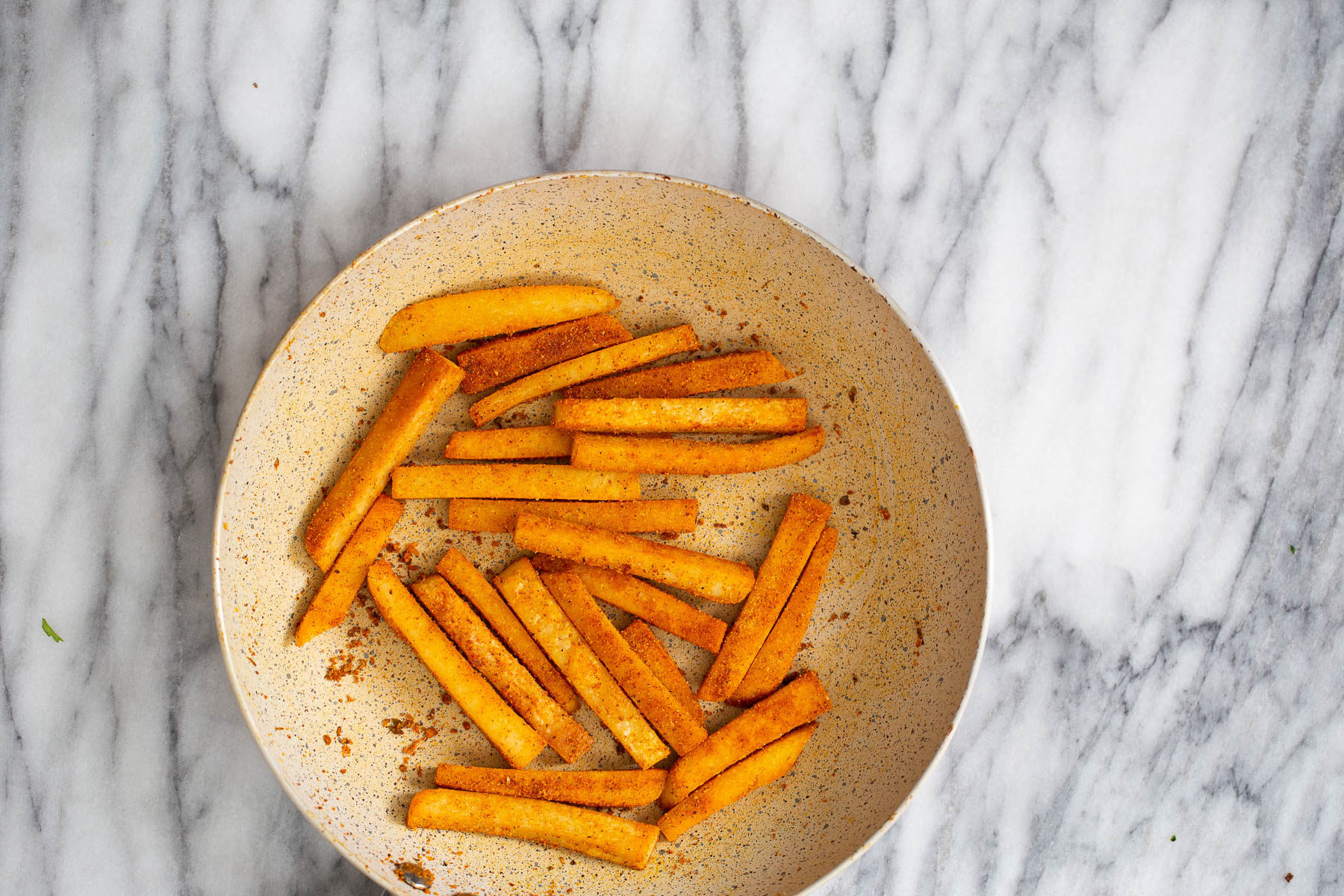 chickpea fries pan fried chickpea flour fries being tossed in salt and Cajun seasoning