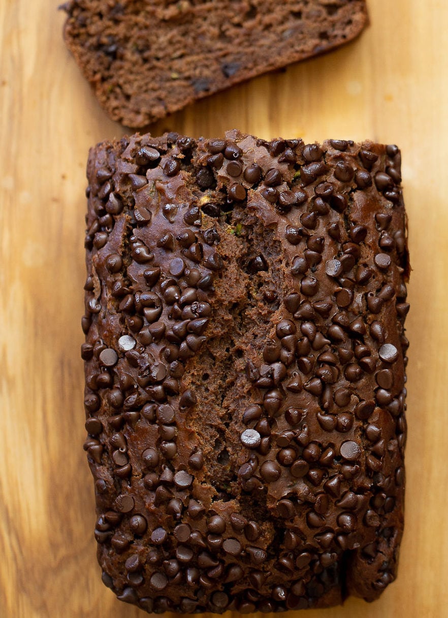 chocolate zucchini bread overhead shot of a loaf of vegan chocolate zucchini bread on a chopping board
