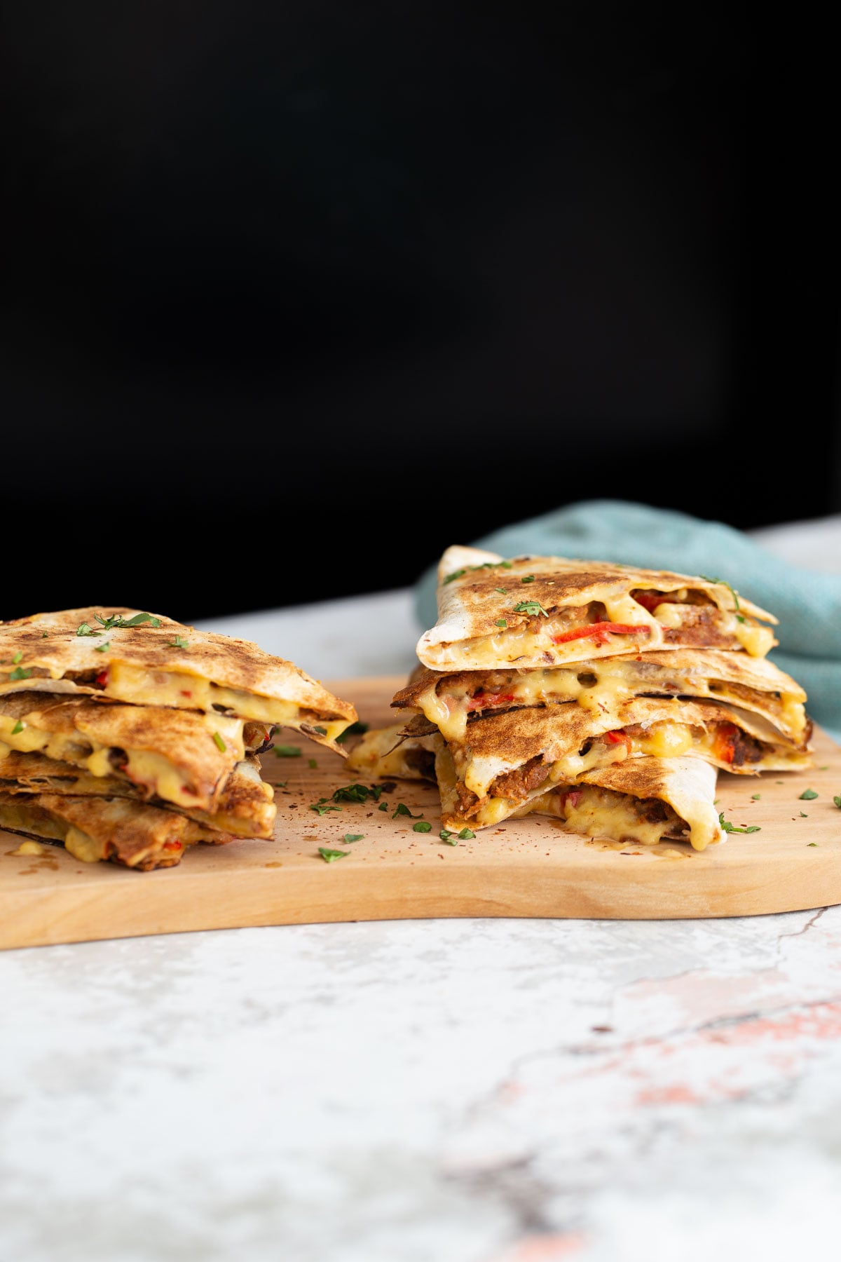 walnut taco meat side view of vegan quesadillas filled with vegan walnut taco meat, bell pepper and melted cheese