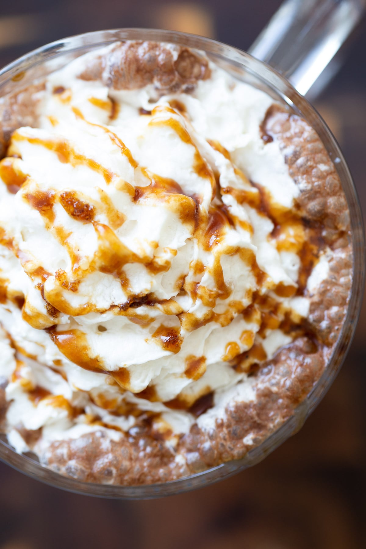 salted caramel mocha overhead shot of a mug of vegan salted caramel mocha topped with whipped coconut cream and caramel syrup
