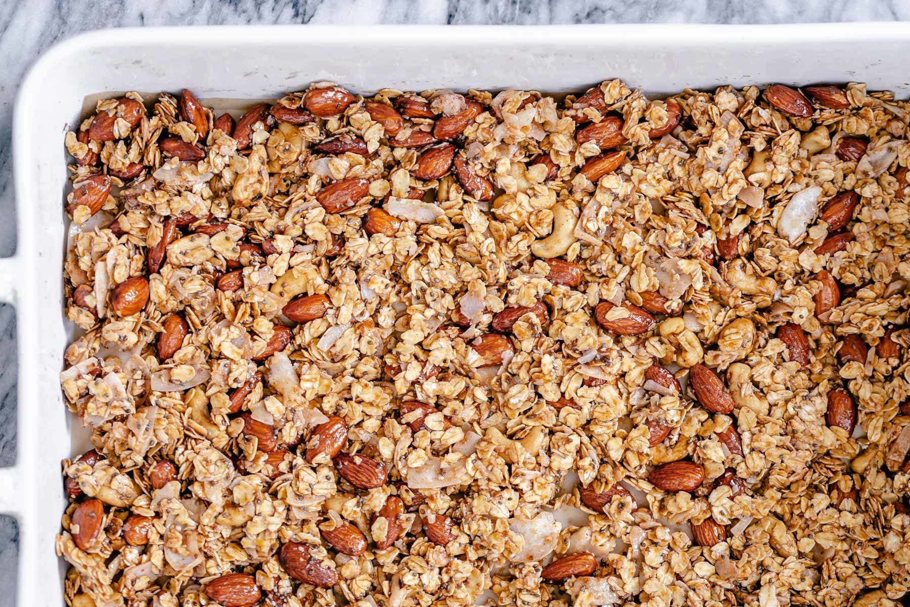 coconut granola overhead shot of a casserole dish with baked almond coconut granola