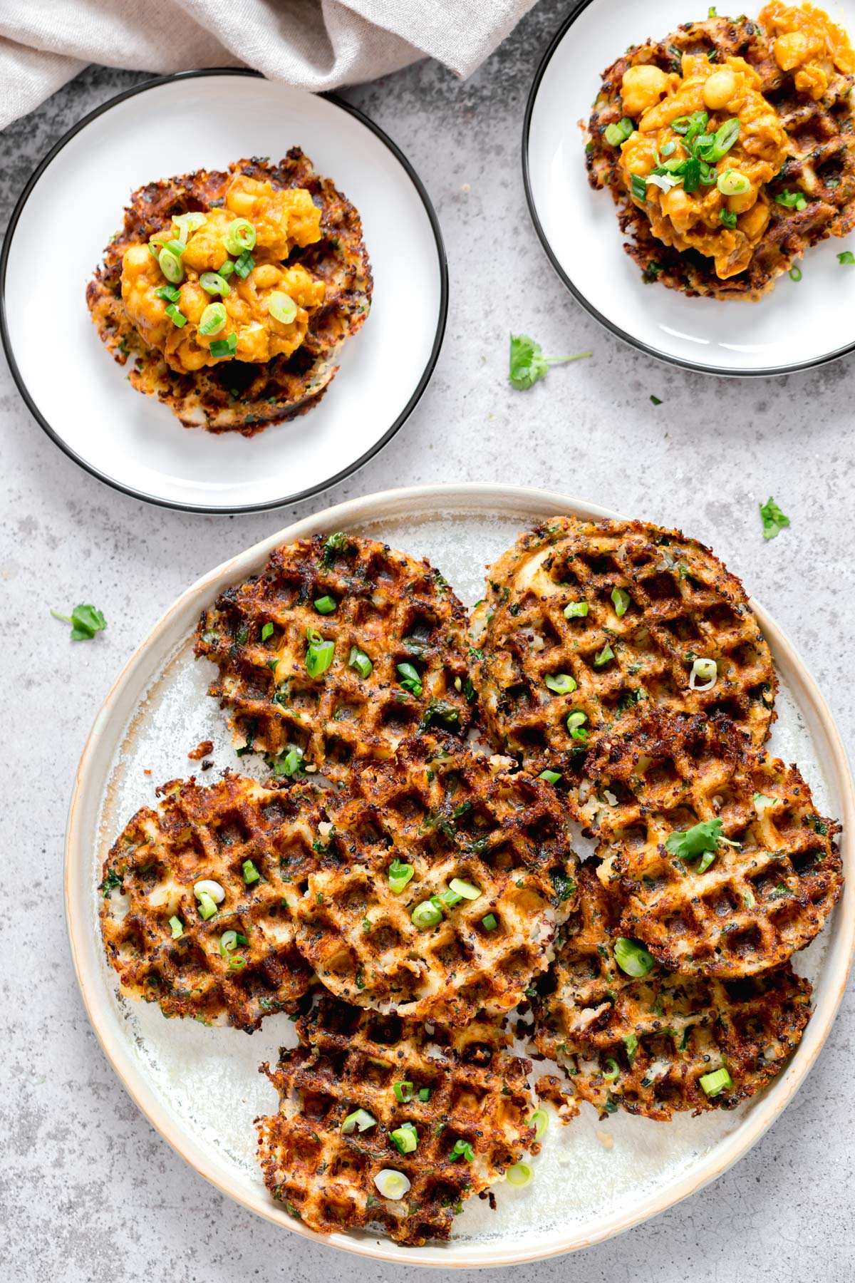 overhead shot of vegan potato quinoa waffles sprinkled with chopped chives
