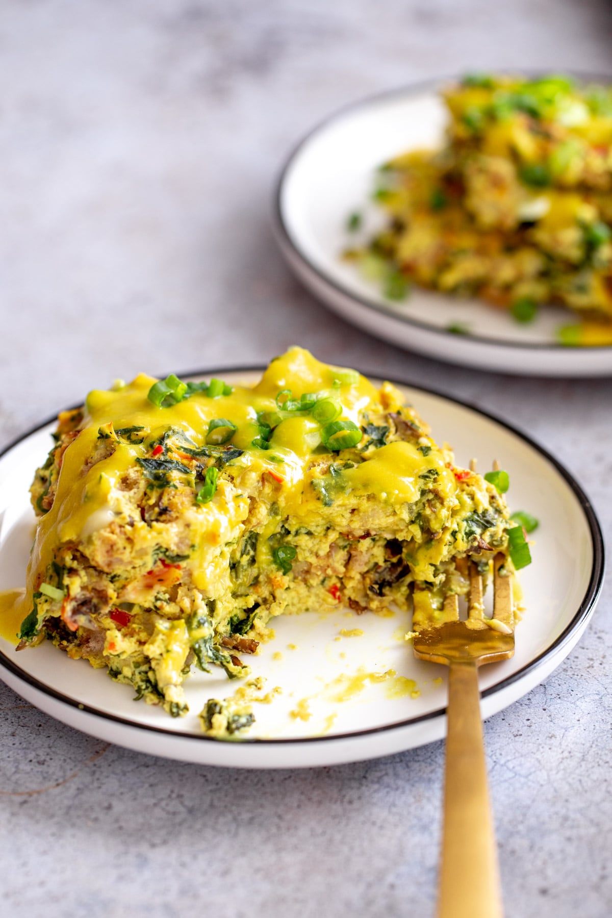 vegan egg casserole on a small plate served with vegan hollandaise sauce