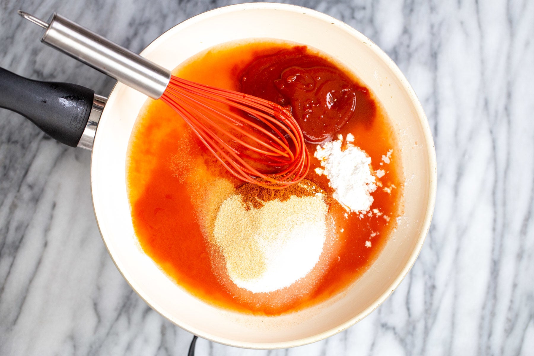 tofu wings firecracker sauce ingredients being stirred together in a small saucepan
