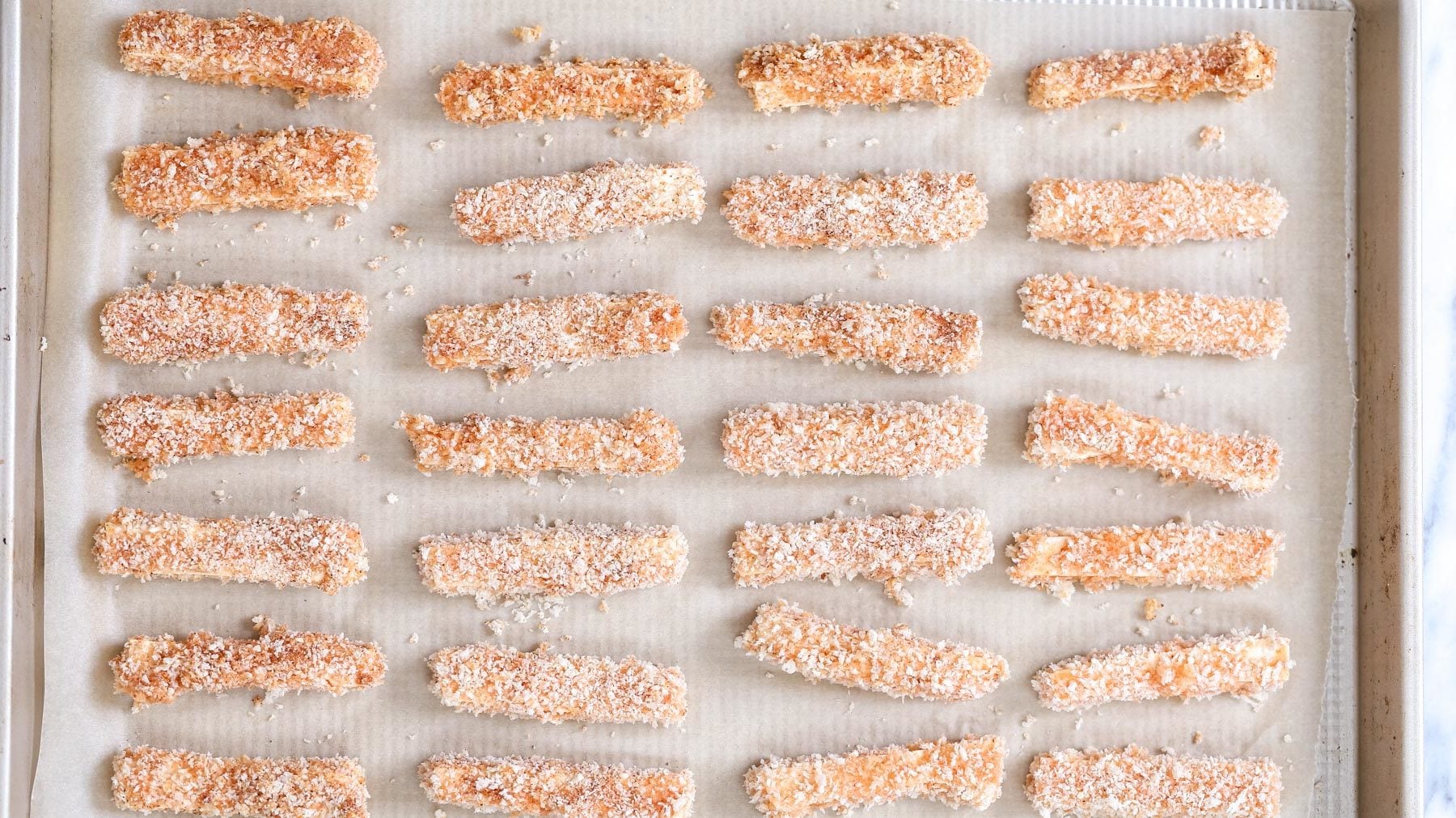 tofu wings breaded vegan tofu wings on.a parchment paper lined baking sheet