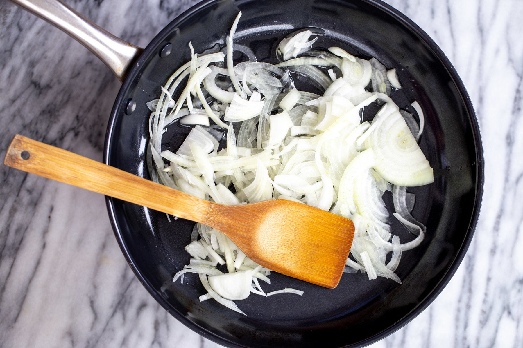 vegan skillet lasagna onion slices in a black skillet