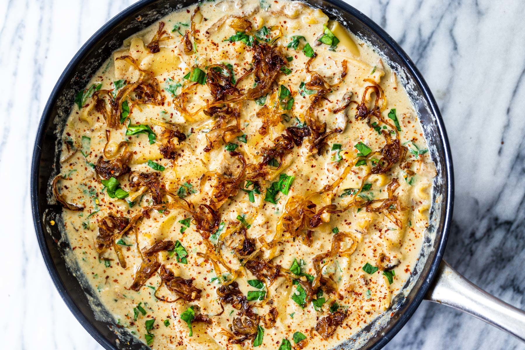 vegan skillet lasagna a black skillet with vegan French Onion Skillet