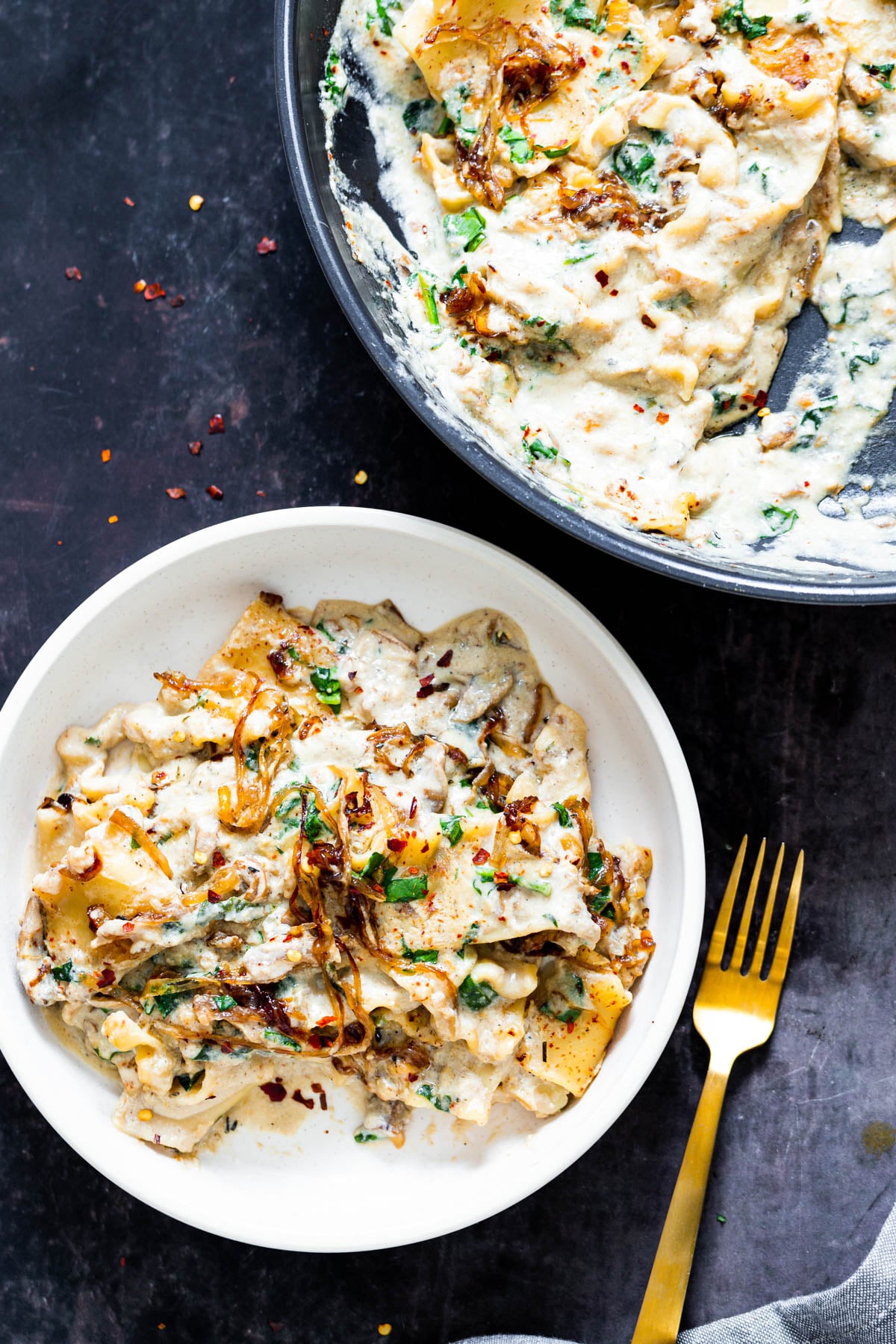 vegan skillet pasta a white bowl with one skillet French Onion Lasagna with spinach and vegan bechamel