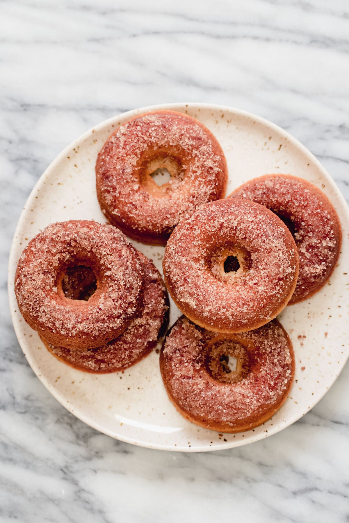 glutenfree donuts recipe a plate with glutenfree donuts coated in cinnamon sugar