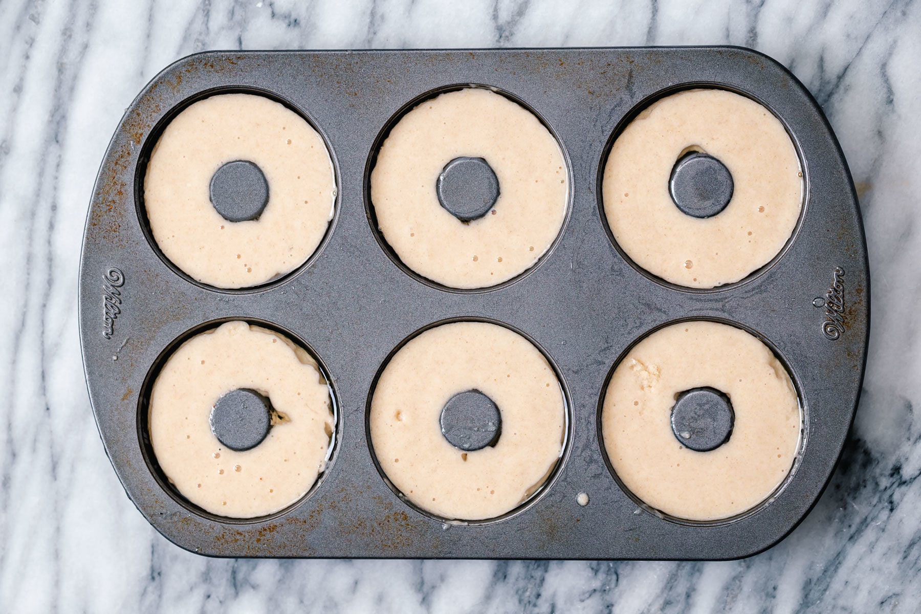 glutenfree donuts recipe glutenfree almond flour donuts batter being filled into donuts pan