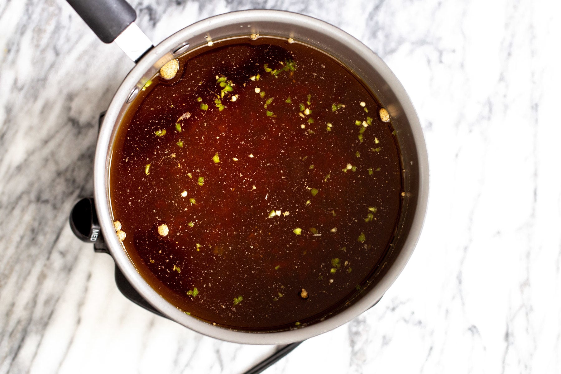 a pot with hot and sour soup broth