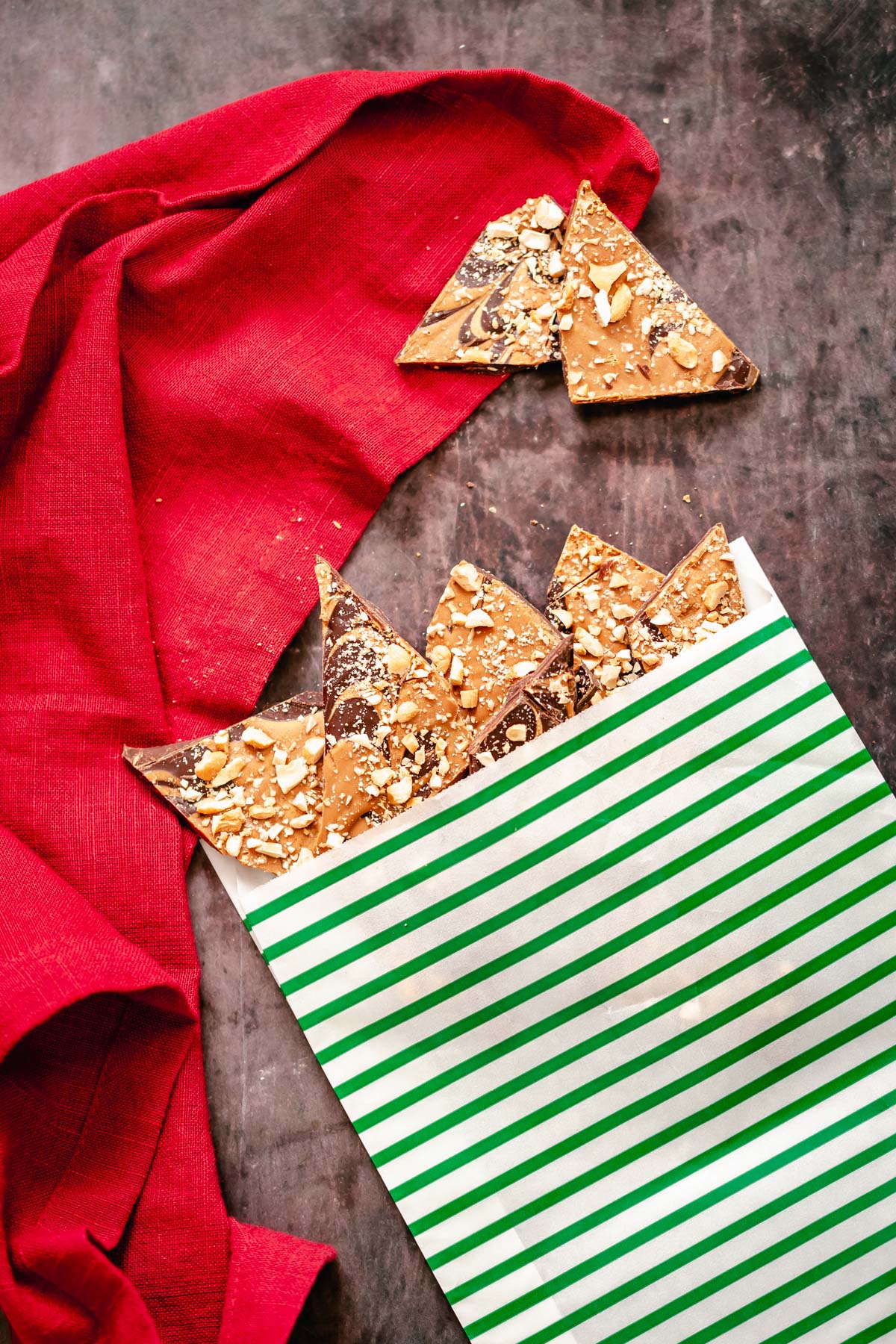 peanut butter chocolate bark homemade vegan peanut butter cup chocolate bark in a green and white Christmas paper bag