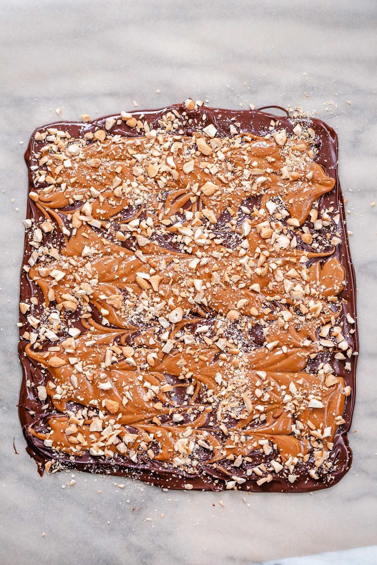 peanut butter chocolate bark overhead shot of set vegan peanut butter cup chocolate bark sprinkled with peanuts