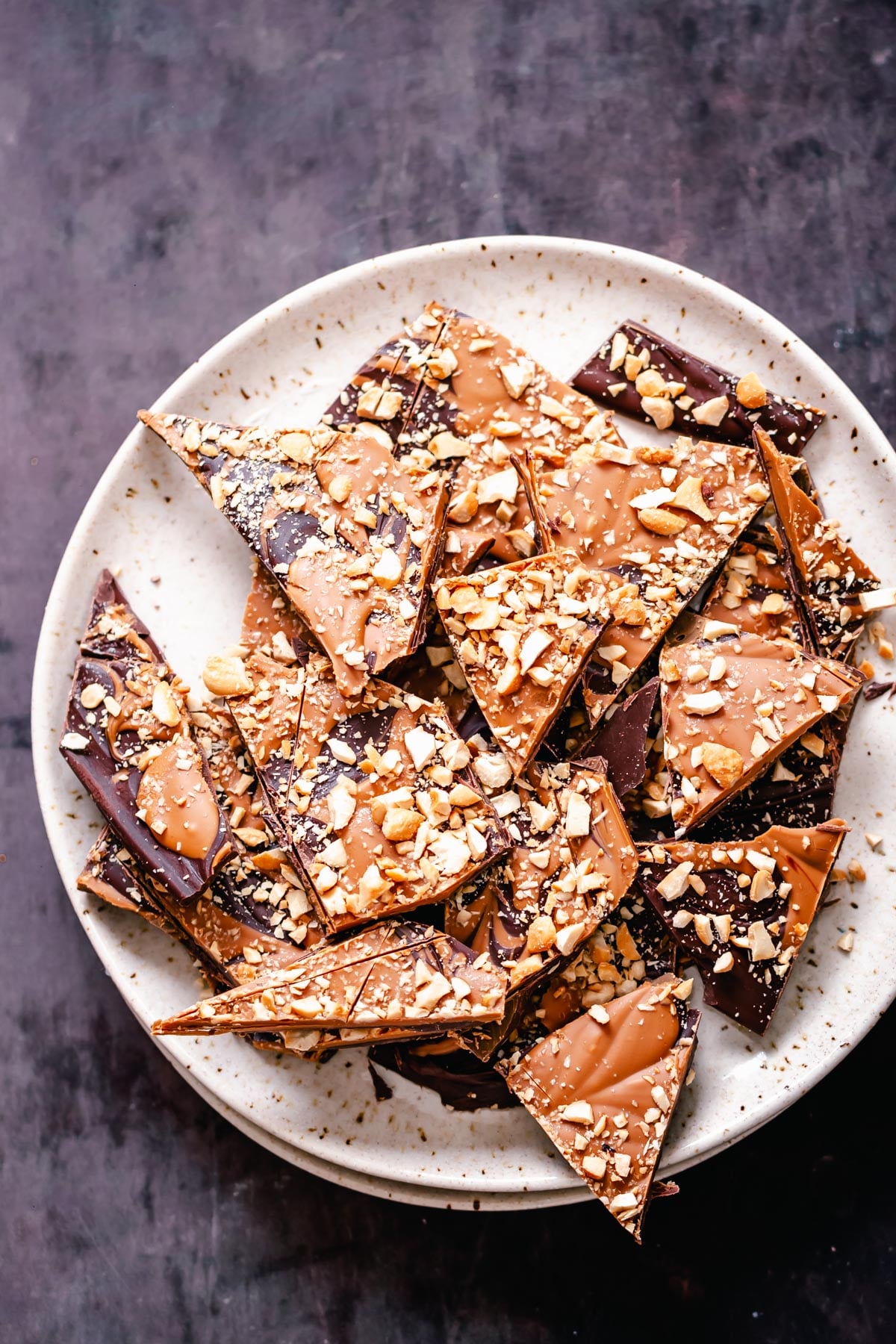 peanut butter chocolate bark overhead shot of a plate with vegan peanut butter chocolate bark with crushed peanuts