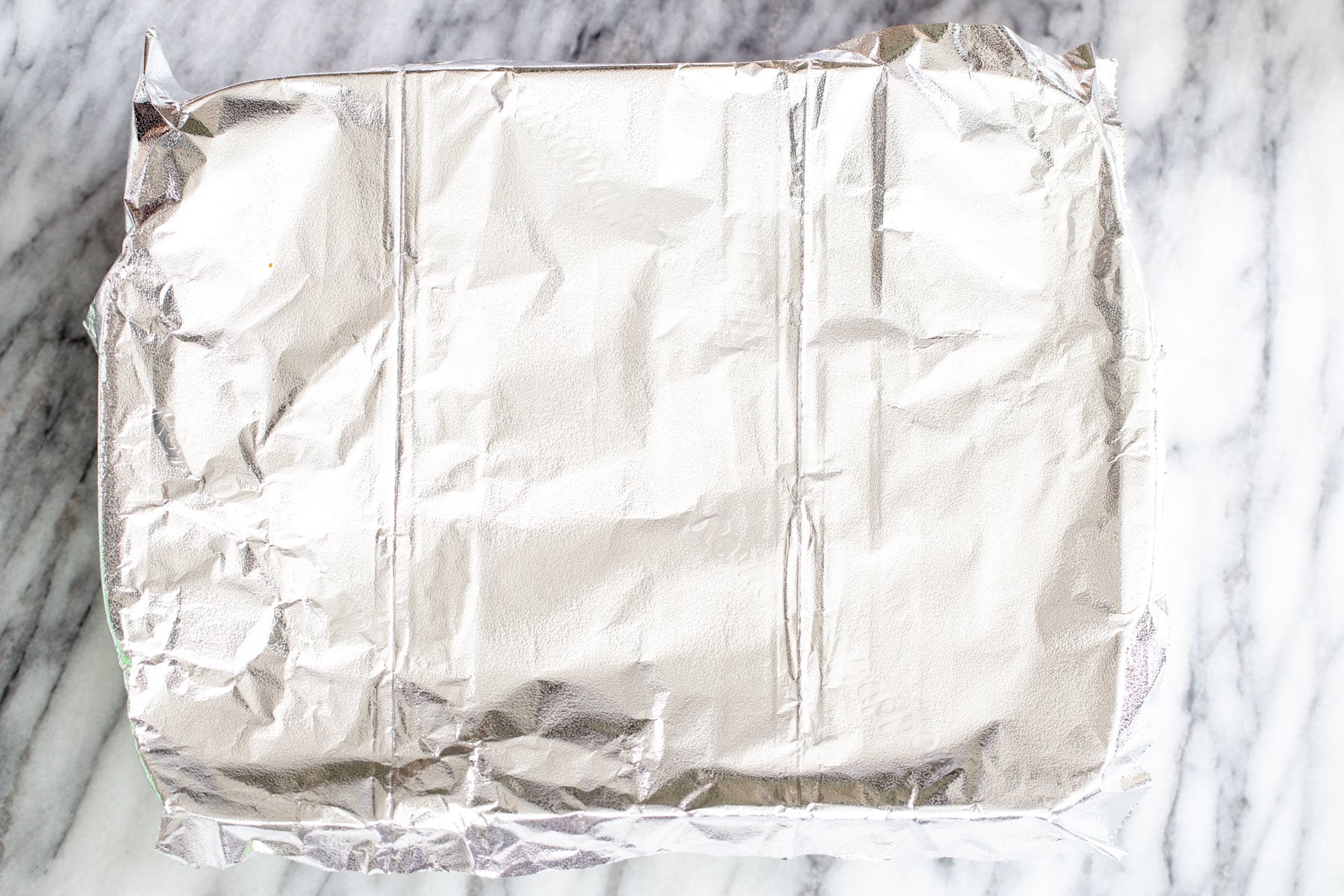 vegan stuffed shells a casserole dish covered with aluminum foil