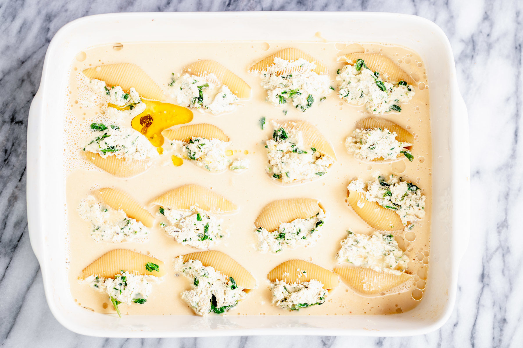 vegan stuffed shells overhead shot of casserole dish with vegan stuffed shells before baking