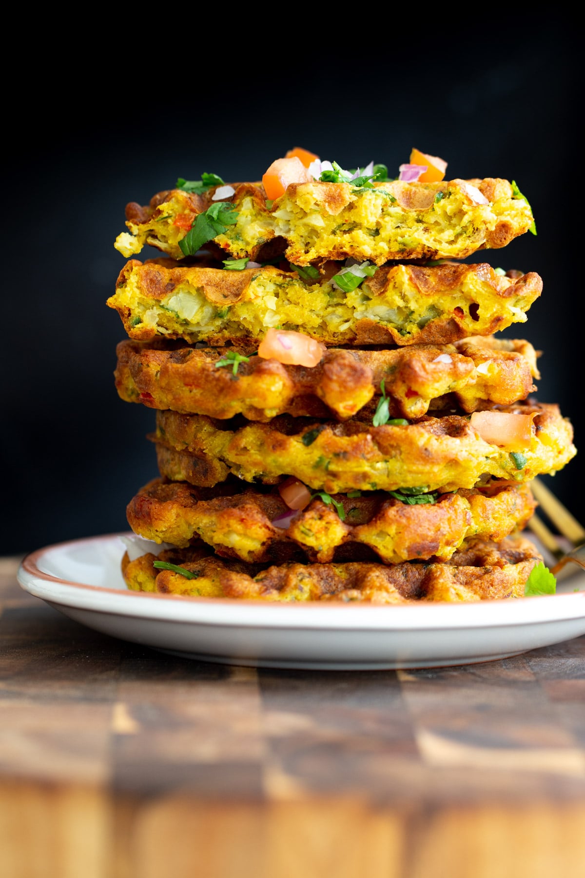 chickpea flour waffles stacked vegan chickpea flour waffles against a black background