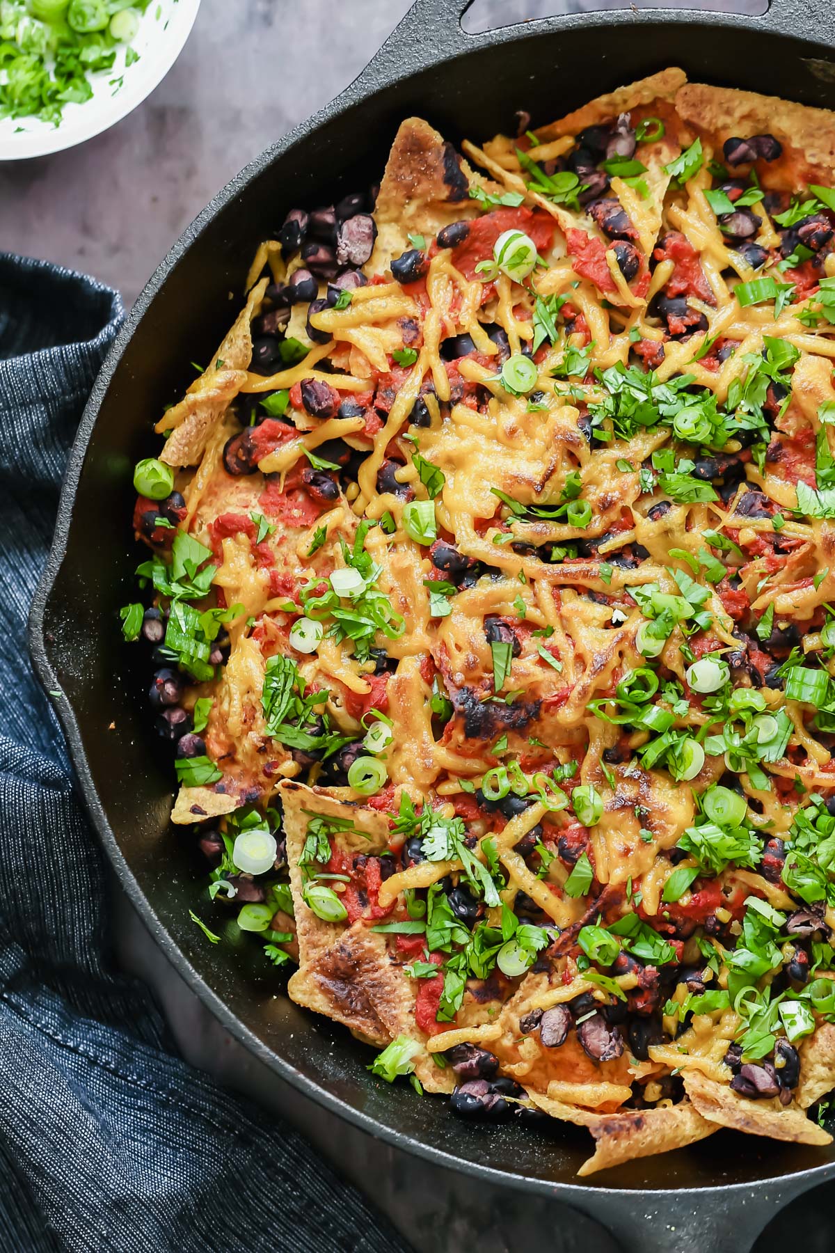 vegan skillet enchiladas close-up overhead shot of vegan skillet enchiladas with tortilla chips, black beans and soy curls