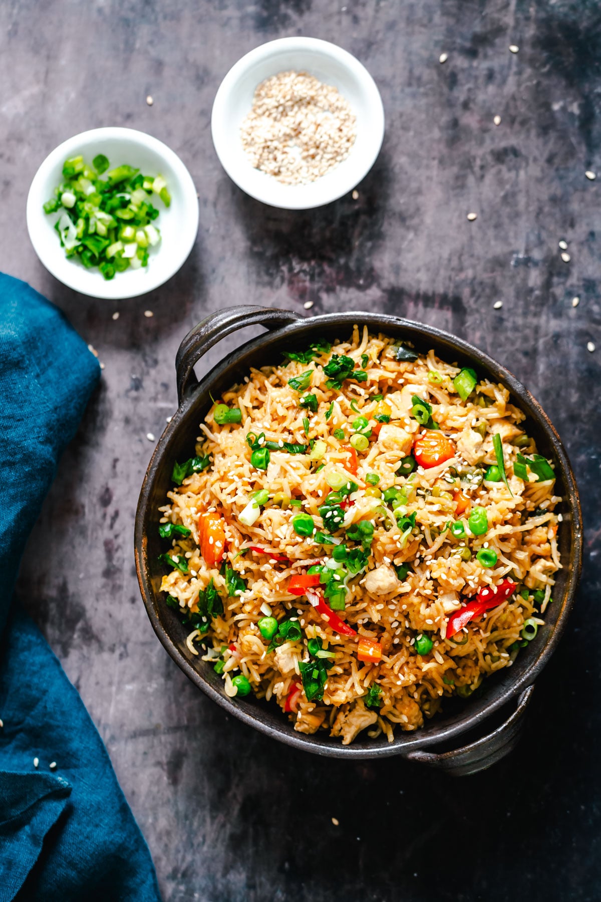 overhead shot it a bowl with vegan instant pot teriyaki fried rice topped with green onions and sesame seeds