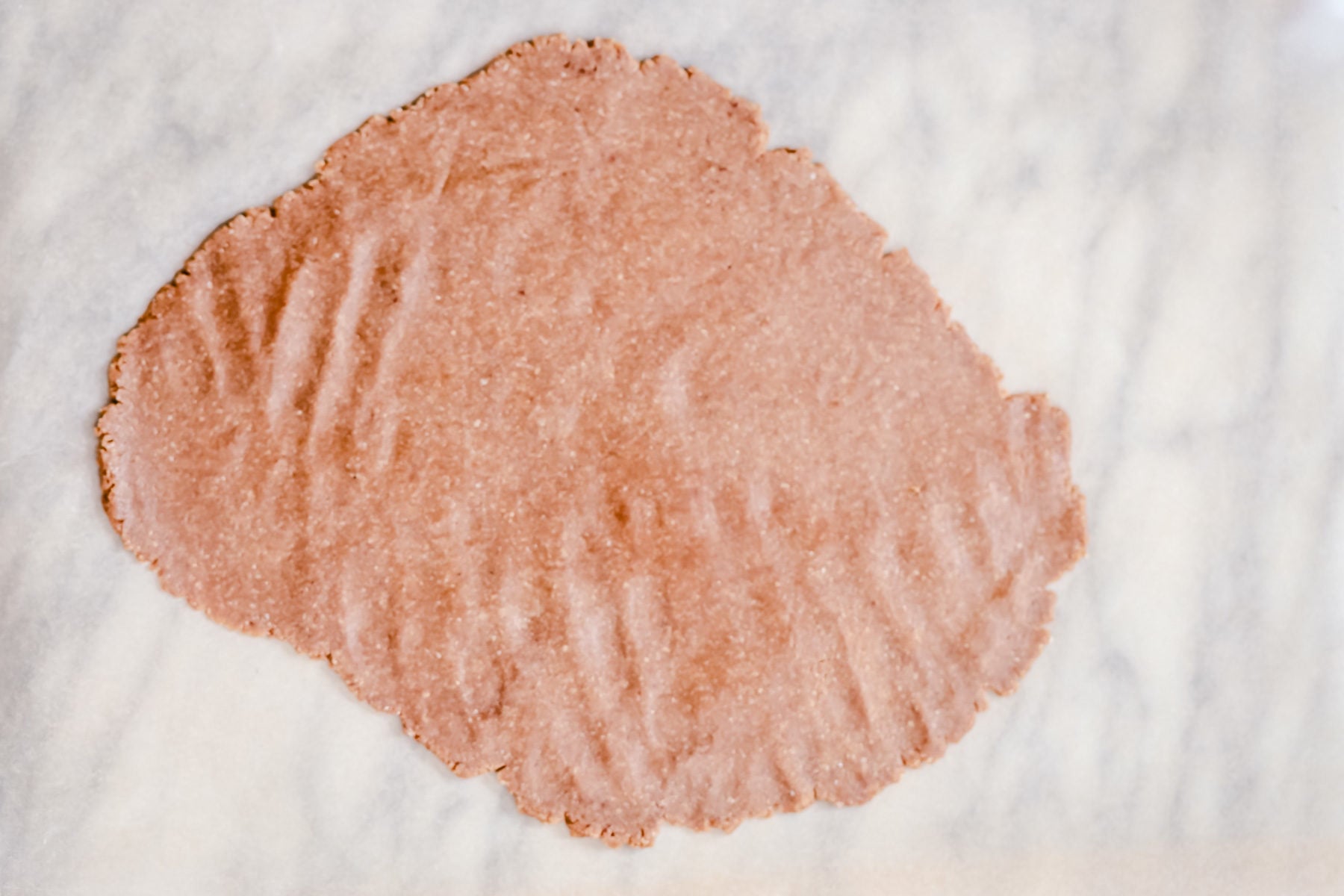vegan gingerbread cookies vegan gingerbread cookie dough rolled out on a marble countertop