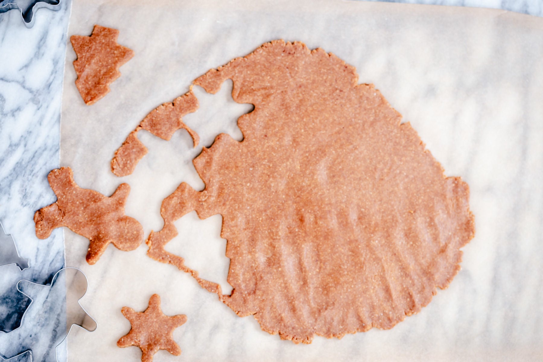 vegan gingerbread men glutenfree cookie dough being but out using a star shaped and a gingerbread cookie cutter