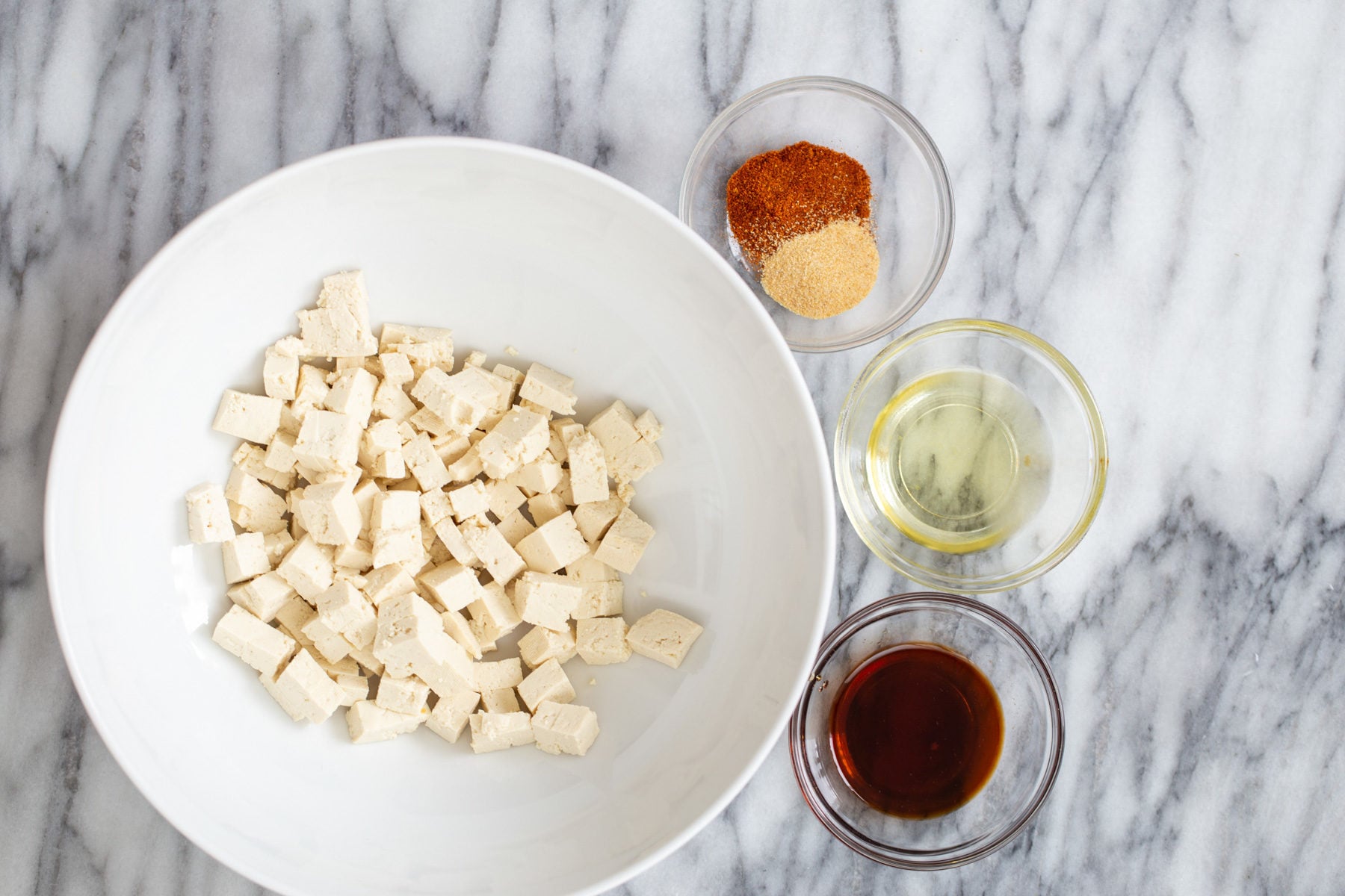 butternut squash carbonara tofu cubes with condiments for making roasted crispy tofu as pasta topping