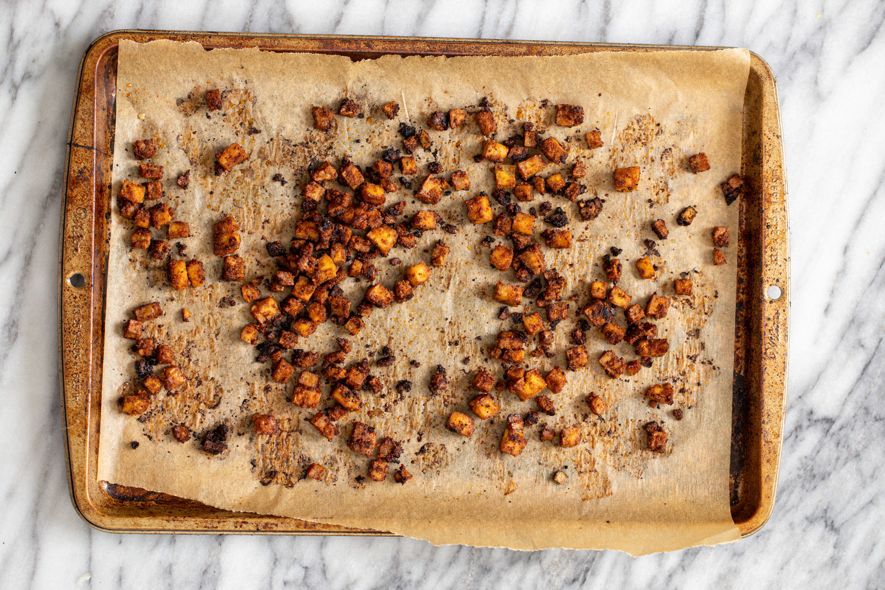 butternut squash carbonara crispy smokey oven roasted tofu cubes on a baking sheet