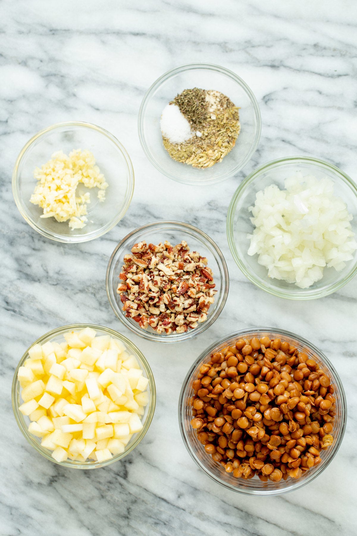 vegan stuffed butternut squash ingredients for making vegan stuffed butternut squash on a marble countertop