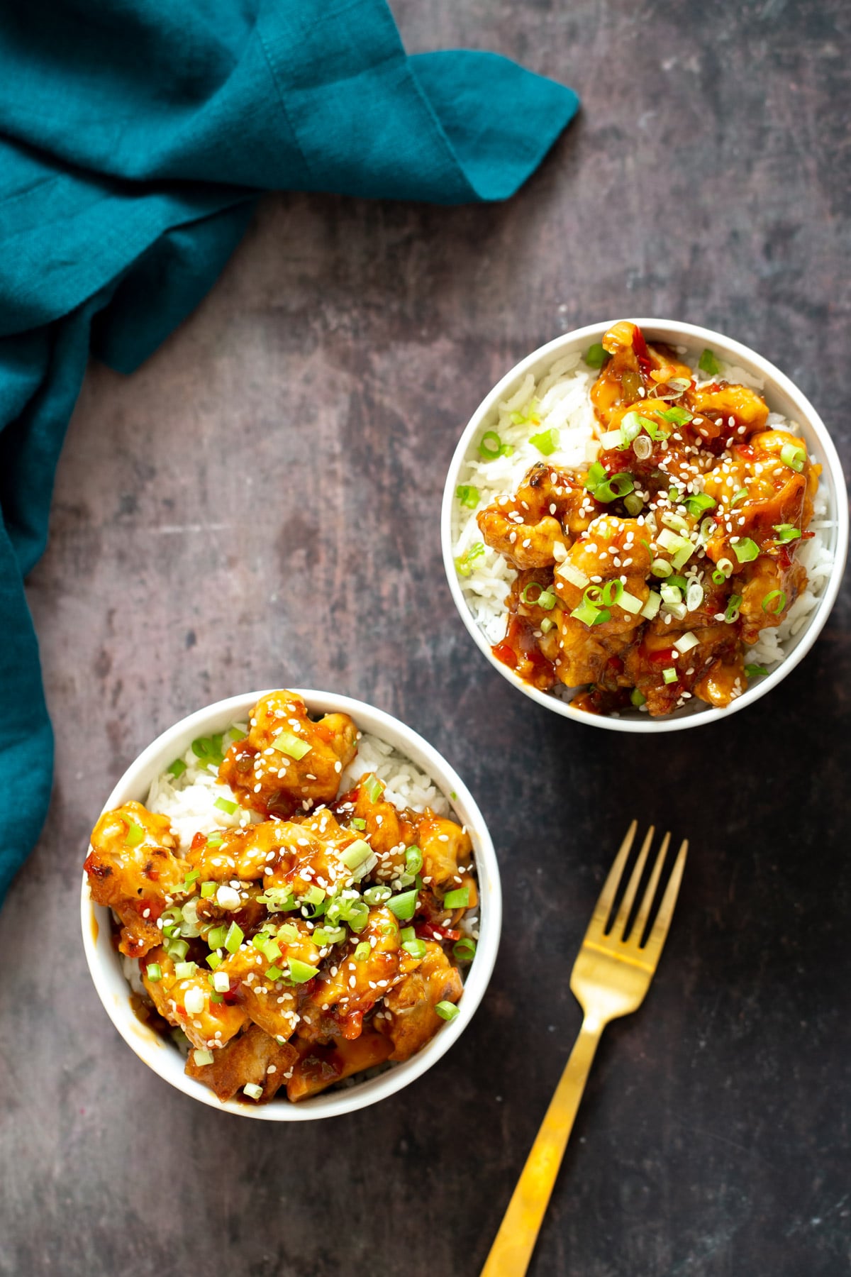 two servings of general tso cauliflower served over rice