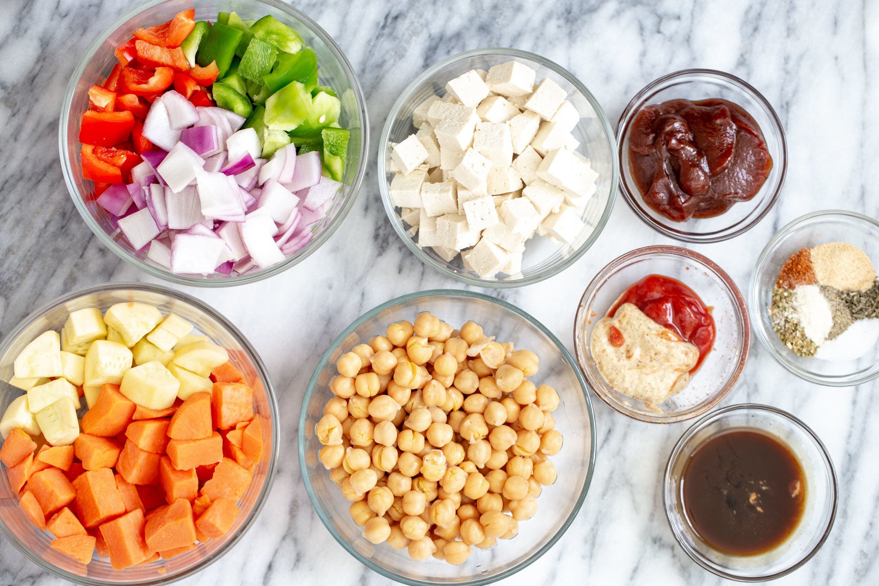 ingredients for making vegan cheeseburger casserole on a marble countertop 