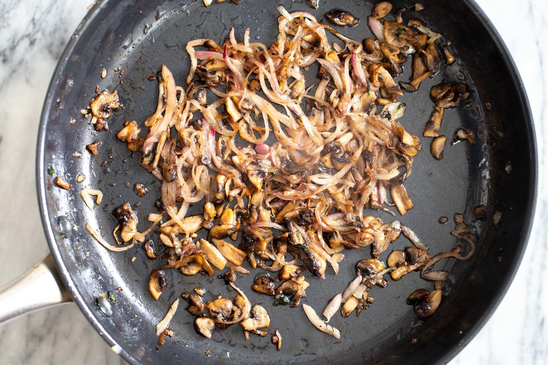 sauteed mushrooms and onions in a frying pan